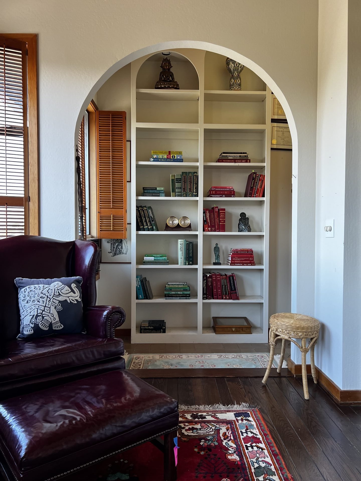 Detail shot of a curated interior design corner with custom decor and a wall of books..